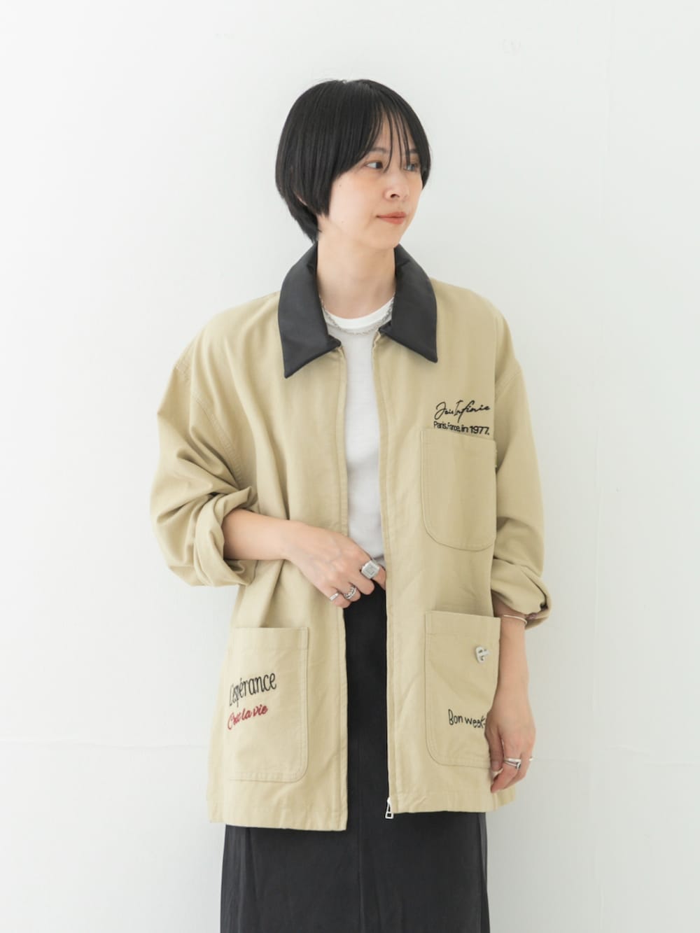 ベージュ系のカバーオール、ホワイト系のTシャツ/カットソー、グレー系のスカートを着用したレディースの夏コーディネートの3枚目の写真