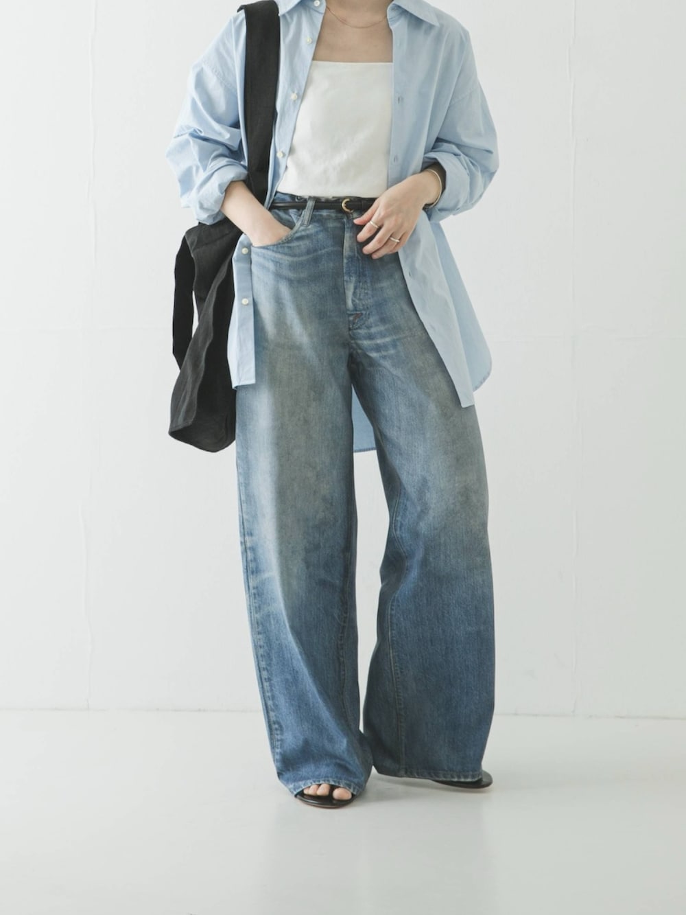 ホワイト系のキャミソール、ブルー系のシャツ/ブラウス、ブラック系のトートバッグを着用したレディースの春コーディネートの4枚目の写真