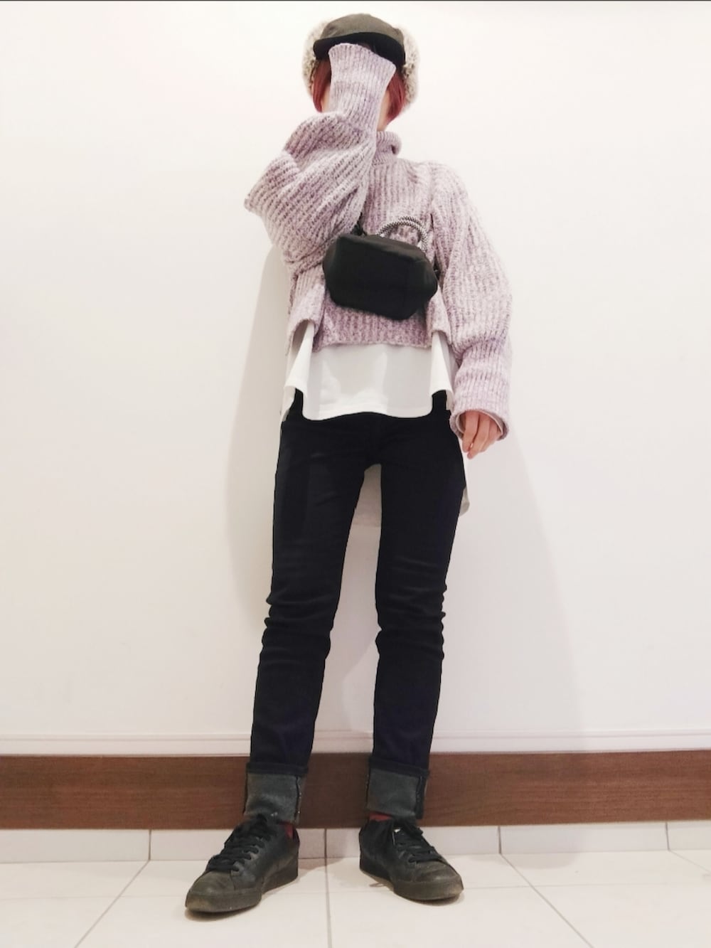 ブラック系のショルダーバッグ、パープル系のニット/セーター、ブルー系のデニムパンツを着用したレディースの冬コーディネートの2枚目の写真