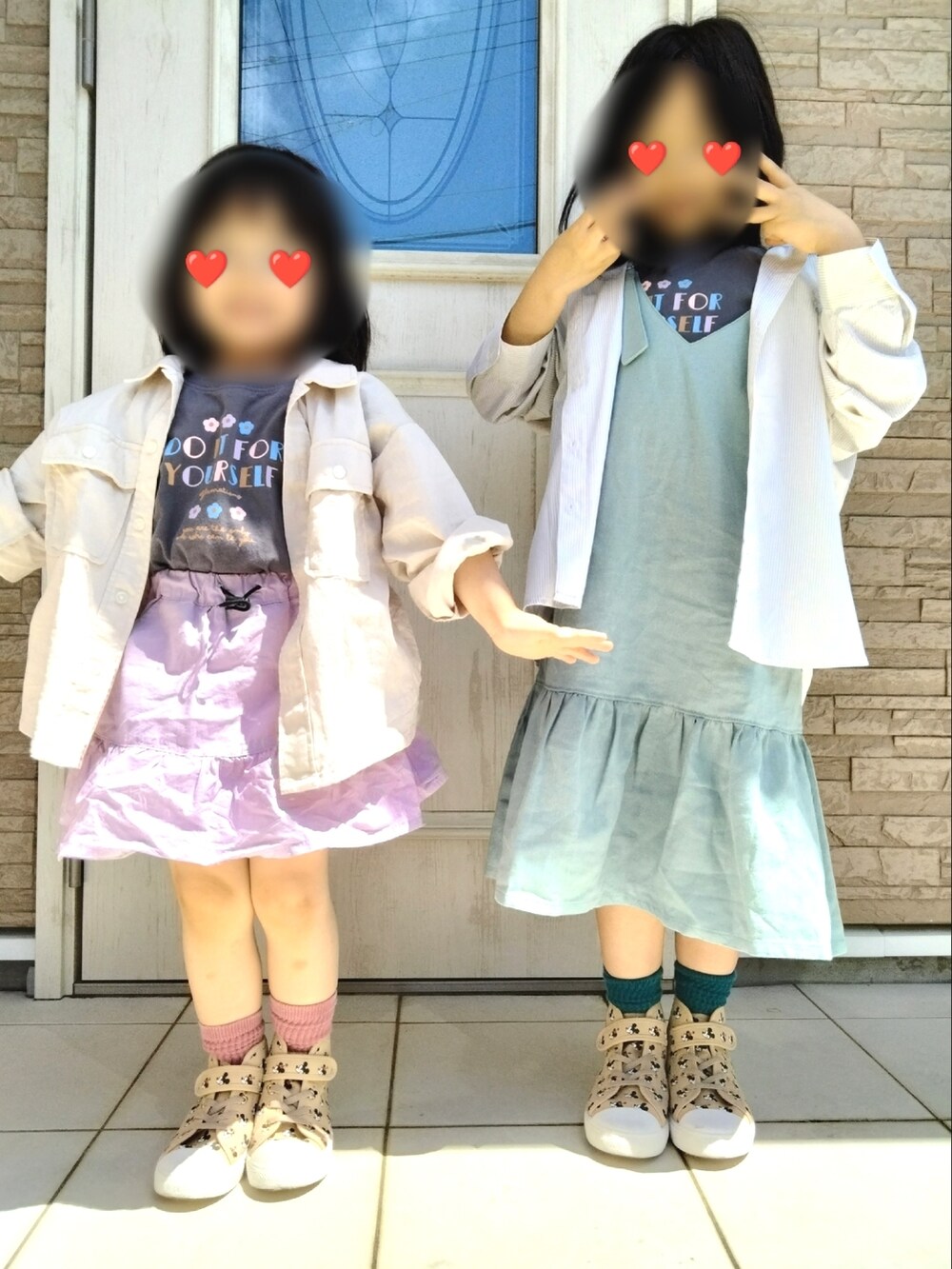 グリーン系のジャンパースカート、ベージュ系のスニーカー、グレー系のTシャツ/カットソーを着用したキッズの春コーディネートの2枚目の写真