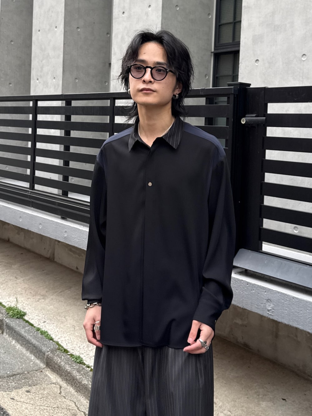 グレー系のスラックス、グレー系のテーラードジャケット、ブラック系のシャツ/ブラウスを着用したメンズの春コーディネートの6枚目の写真