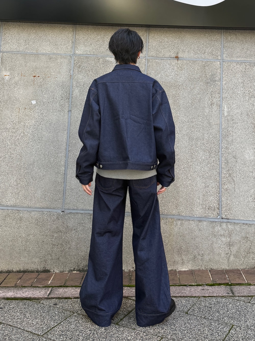 ブルー系のデニムジャケット、ブラック系のローファー、ブルー系のデニムパンツを着用したメンズの秋コーディネートの3枚目の写真