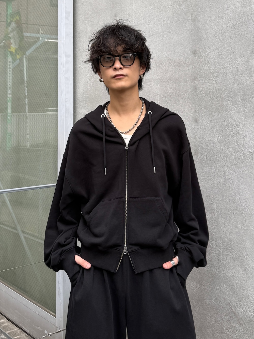 ブラック系のパーカー、ブラック系のスウェットパンツを着用したメンズの秋コーディネートの4枚目の写真