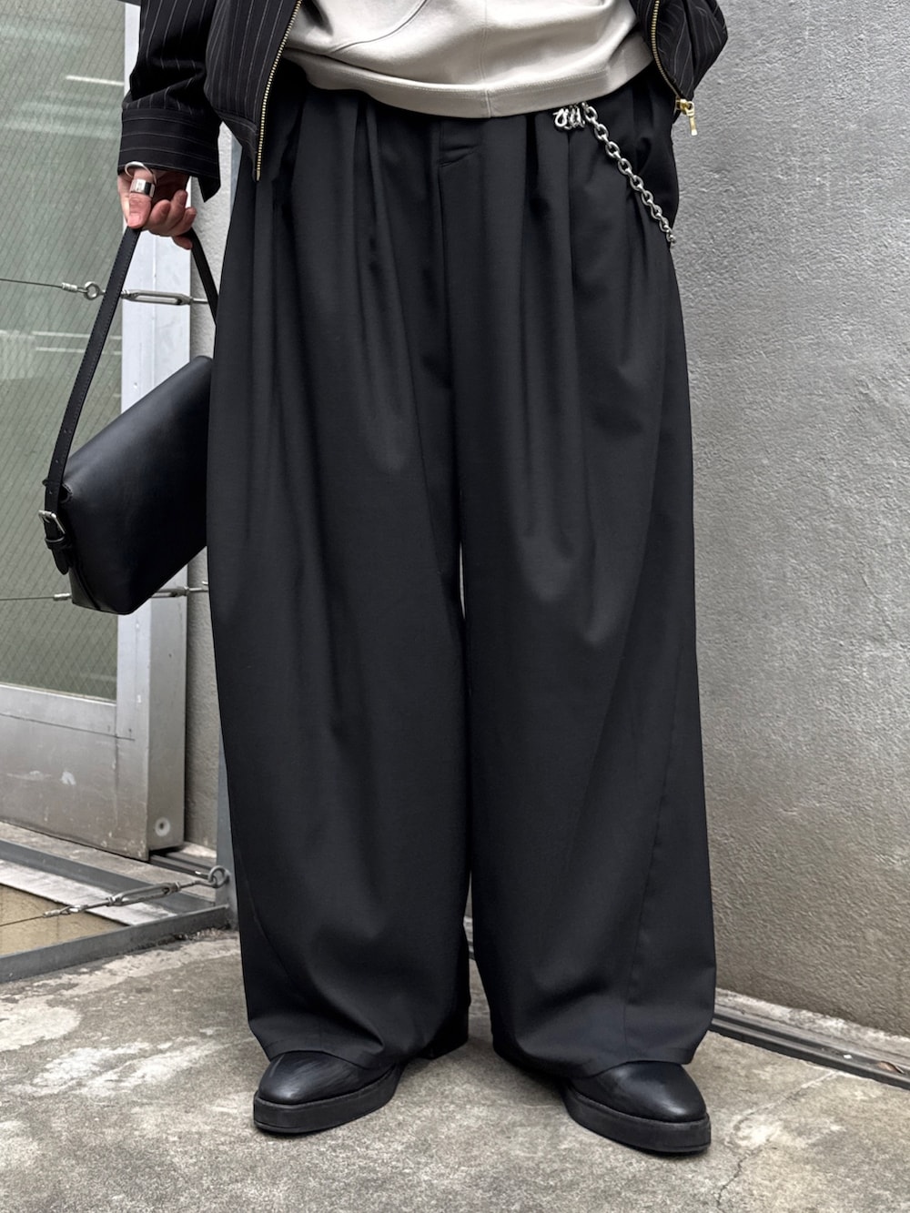 ブラック系のその他パンツ、ブラック系のハンドバッグ、グレー系のTシャツ/カットソーを着用したメンズの春コーディネートの7枚目の写真