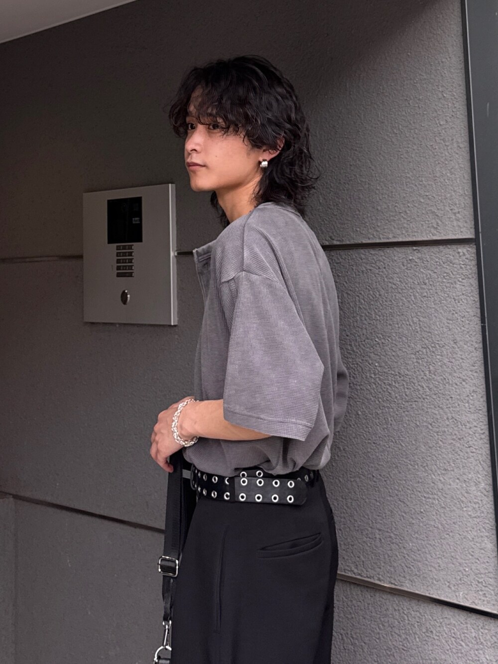 グレー系のTシャツ/カットソー、ブラック系のショルダーバッグ、ブラック系のスラックスを着用したメンズの春コーディネートの6枚目の写真