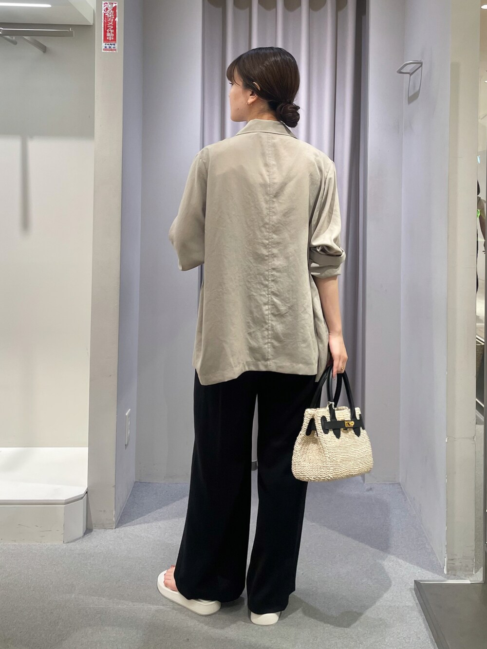 ベージュ系のテーラードジャケット、ホワイト系のタンクトップ、ブラック系のサロペット/オーバーオールを着用したレディースの夏コーディネートの4枚目の写真