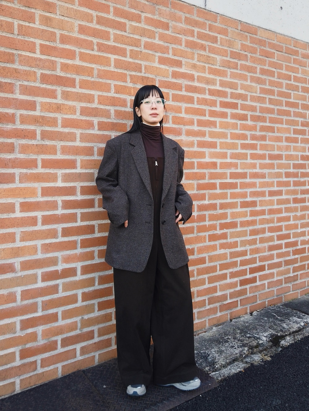 ブラウン系のサロペット/オーバーオール、ブラウン系のテーラードジャケット、グレー系のスニーカーを着用したレディースの冬コーディネートの4枚目の写真