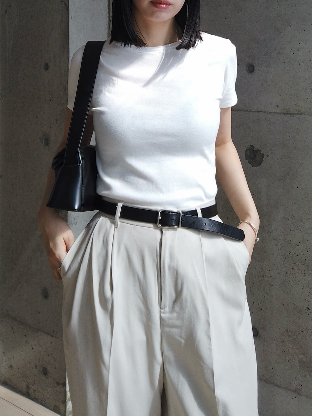 ベージュ系のその他パンツ、ホワイト系のTシャツ/カットソー、ブラック系のショルダーバッグを着用したレディースの夏コーディネートの2枚目の写真