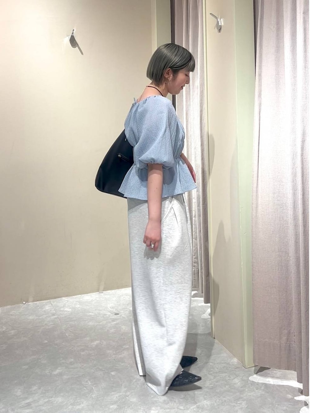 ブラック系のショルダーバッグ、グレー系のスウェットパンツ、ブラック系のパンプスを着用したレディースの春コーディネートの2枚目の写真