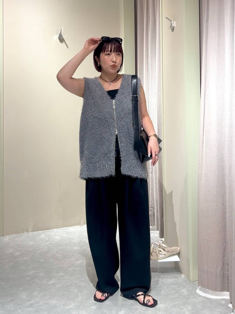 ブラック系のショルダーバッグ、ブラック系のスウェットパンツ、ブラック系のタンクトップを着用したレディースの秋コーディネートの9枚目の写真
