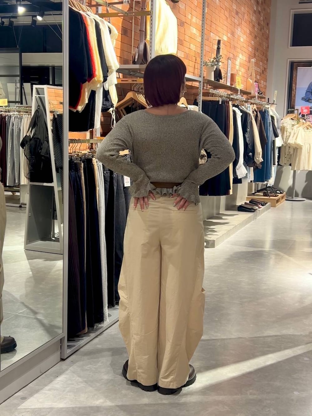 ブラウン系のブーツ、ベージュ系のその他パンツ、グレー系のカーディガン/ボレロを着用したレディースの秋コーディネートの2枚目の写真