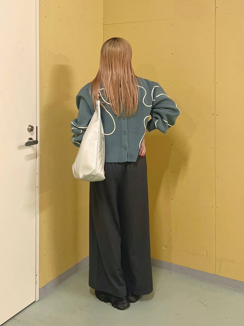 ブラック系のブーツ、シルバー系のトートバッグ、グレー系のその他パンツを着用したレディースの冬コーディネートの3枚目の写真