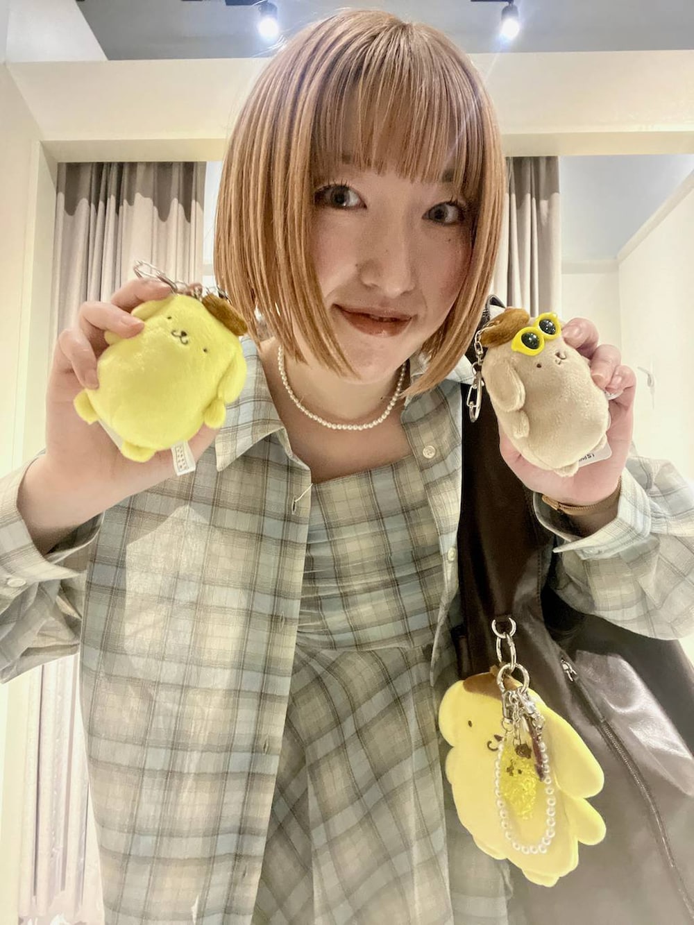 ブルー系のデニムパンツ、イエロー系のエコバッグ/サブバッグ、ブラウン系のショルダーバッグを着用したレディースの春コーディネートの2枚目の写真