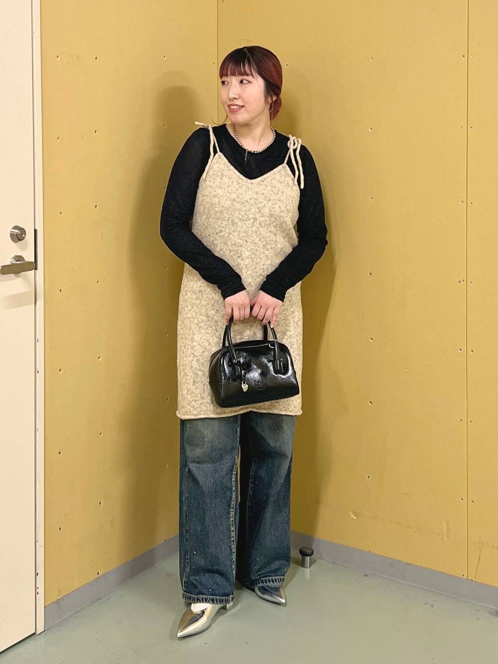 シルバー系のパンプス、ブルー系のデニムパンツ、ブラック系のTシャツ/カットソーを着用したレディースの秋コーディネートの4枚目の写真