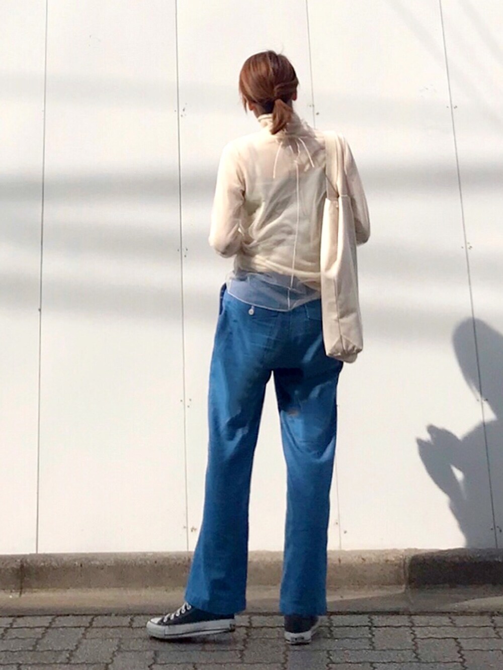 ブルー系のその他パンツ、ホワイト系のTシャツ/カットソー、ホワイト系のトートバッグを着用したレディースの春コーディネートの2枚目の写真