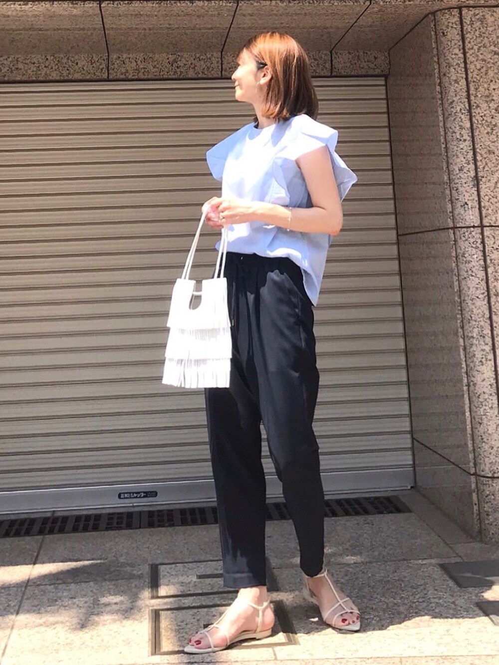 ブルー系のシャツ/ブラウス、ホワイト系のサンダル、ホワイト系のショルダーバッグを着用したレディースの夏コーディネートの4枚目の写真