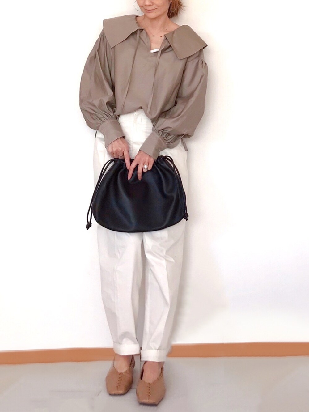 グリーン系のシャツ/ブラウス、ホワイト系のその他パンツ、ブラウン系のハンドバッグを着用したレディースの冬コーディネートの2枚目の写真