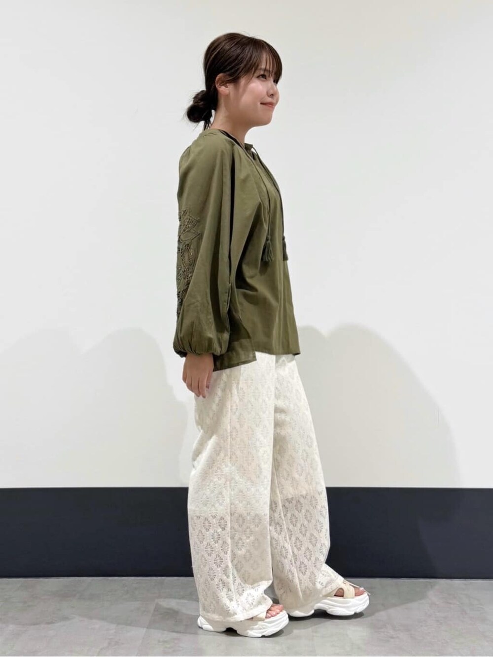 グリーン系のシャツ/ブラウス、ホワイト系のその他パンツ、ブラック系のショルダーバッグを着用したレディースの夏コーディネートの2枚目の写真