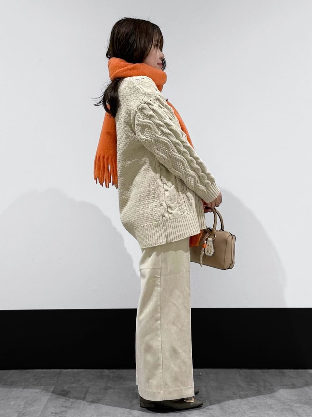 ホワイト系のニット/セーター、ホワイト系のその他パンツ、ベージュ系のボストンバッグを着用したレディースの冬コーディネートの3枚目の写真
