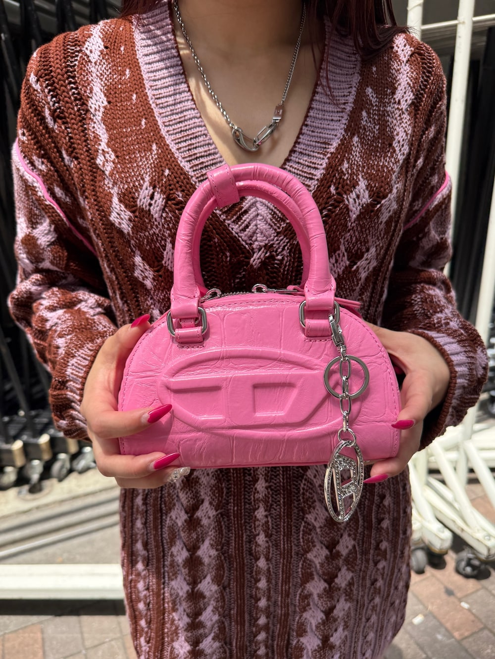ブラック系のデニムパンツ、パープル系のドレス、ホワイト系のスニーカーを着用したレディースの夏コーディネートの3枚目の写真