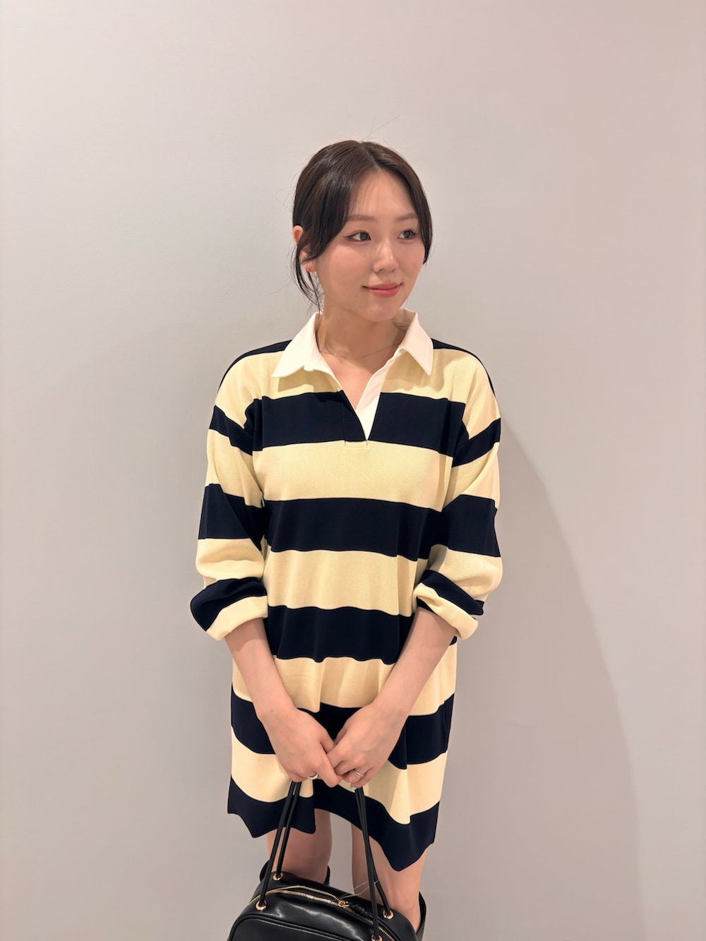 ブルー系のワンピース、ブラック系のボストンバッグ、ブラック系のブーツを着用したレディースの夏コーディネートの5枚目の写真