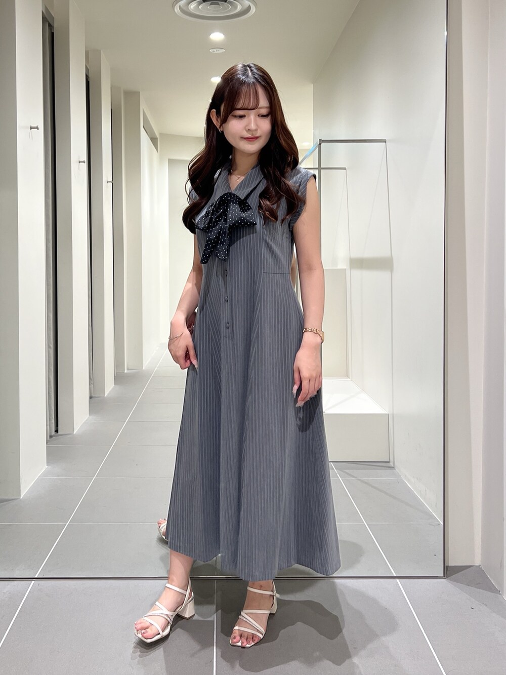 グレー系のワンピースを着用したレディースの夏コーディネートの2枚目の写真