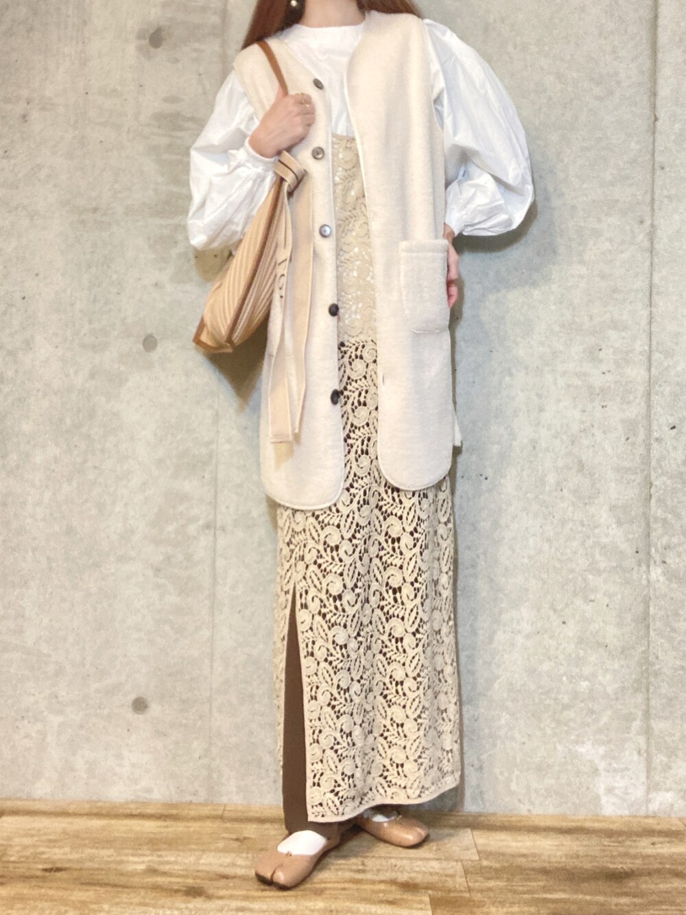 ホワイト系のシャツ/ブラウス、ベージュ系のベスト、ベージュ系のワンピースを着用したレディースの冬コーディネートの2枚目の写真