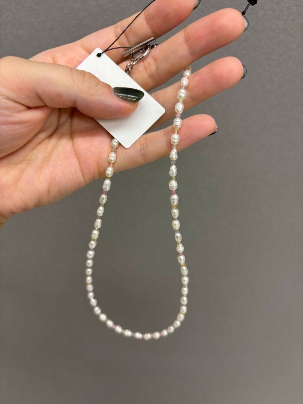 ホワイト系のキャミソール、グレー系のTシャツ/カットソー、ホワイト系のネックレスを着用したレディースの夏コーディネートの8枚目の写真