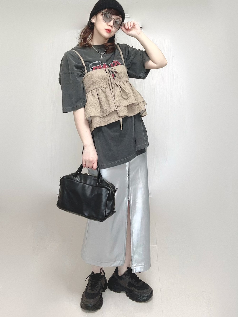 グレー系のTシャツ/カットソー、ベージュ系のキャミソール、シルバー系のスカートを着用したレディースの春コーディネートの3枚目の写真