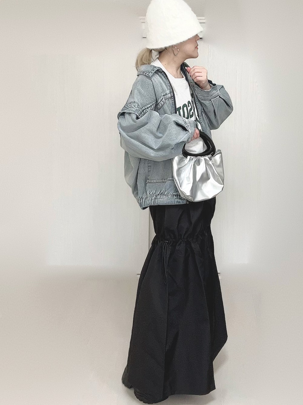 ブルー系のブルゾン、ブラック系のスカート、ブラック系のスニーカーを着用したレディースの春コーディネートの3枚目の写真