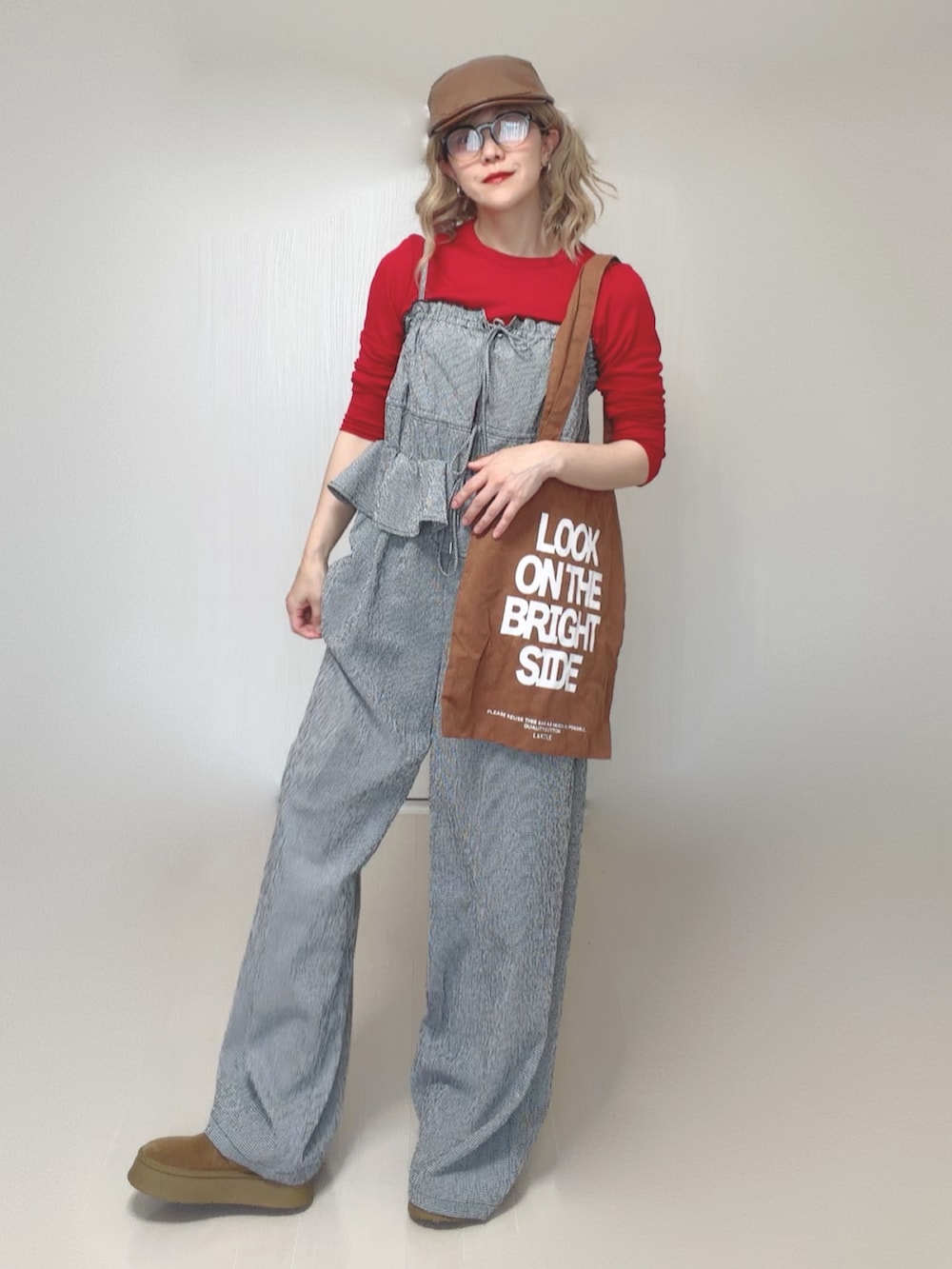 グレー系のサロペット/オーバーオール、ブラウン系のトートバッグ、レッド系のTシャツ/カットソーを着用したレディースの夏コーディネートの3枚目の写真