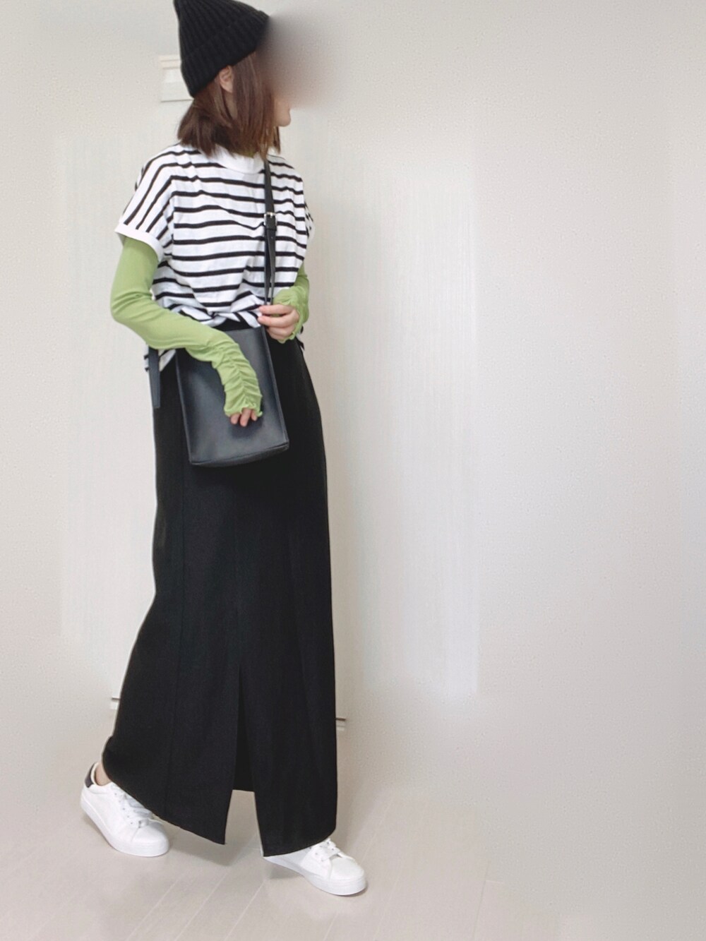 ホワイト系のTシャツ/カットソー、ブラック系のスカート、ホワイト系のスニーカーを着用したレディースの夏コーディネートの3枚目の写真