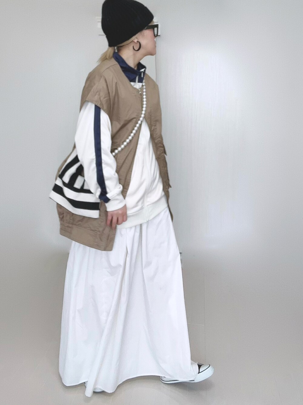 ベージュ系のジャケット/アウター、ベージュ系のジャージ、ホワイト系のショルダーバッグを着用したレディースの冬コーディネートの5枚目の写真