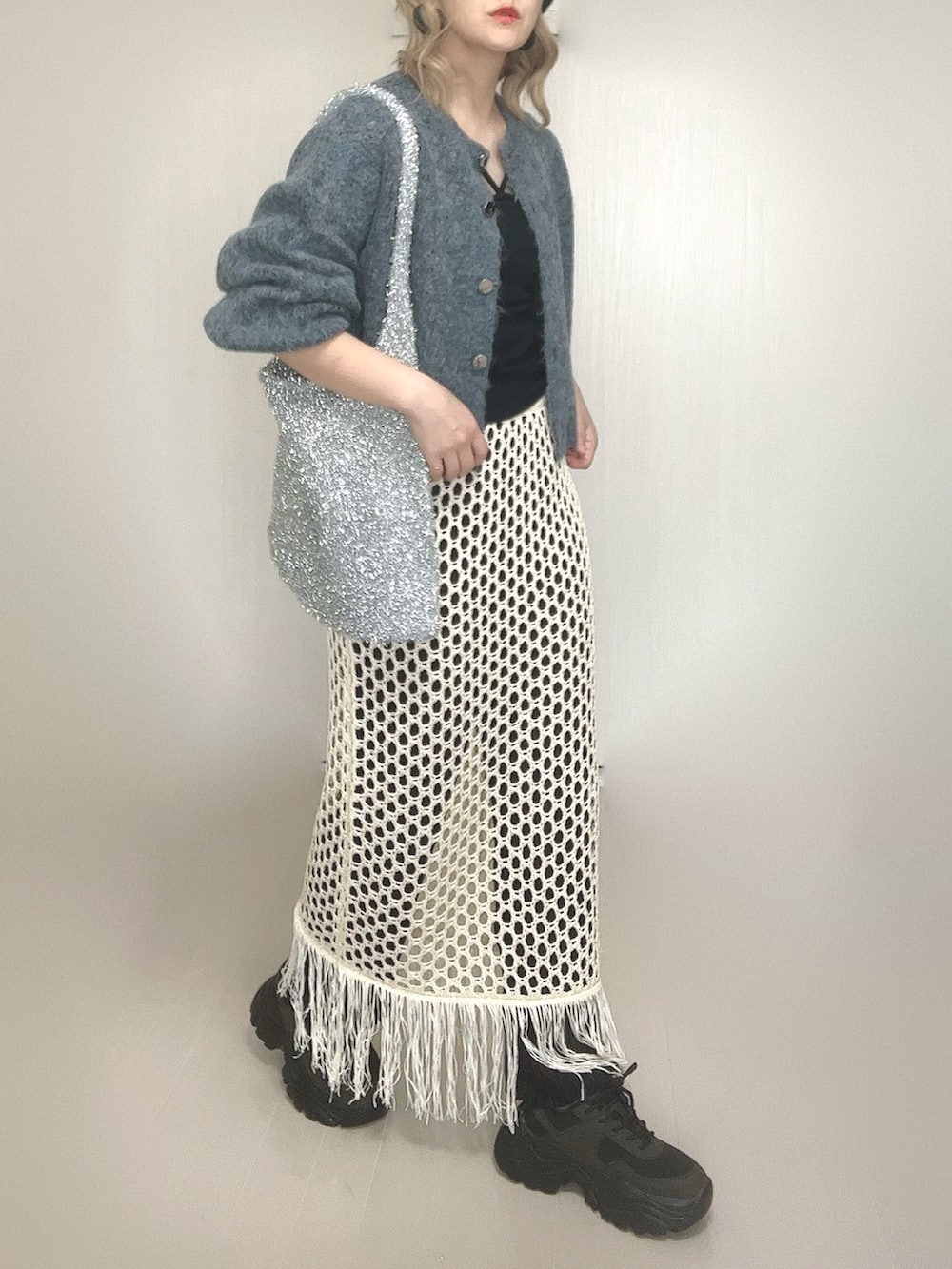 ブルー系のカーディガン/ボレロ、ブラック系のキャミソール、ホワイト系のスカートを着用したレディースの秋コーディネートの4枚目の写真