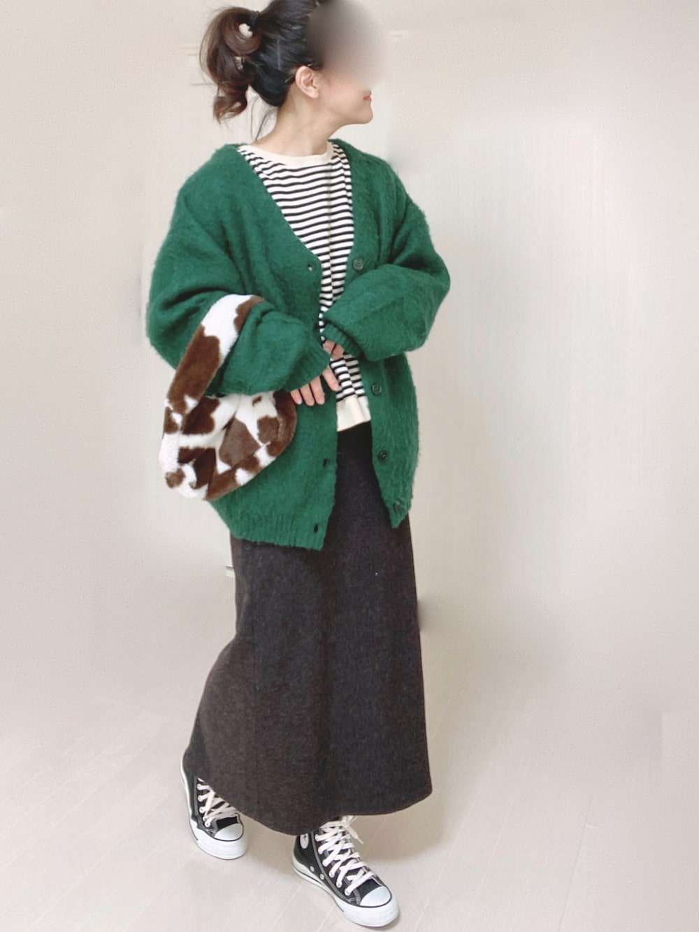 グリーン系のカーディガン/ボレロ、ブラック系のTシャツ/カットソー、ブラック系のスニーカーを着用したレディースの秋コーディネートの2枚目の写真