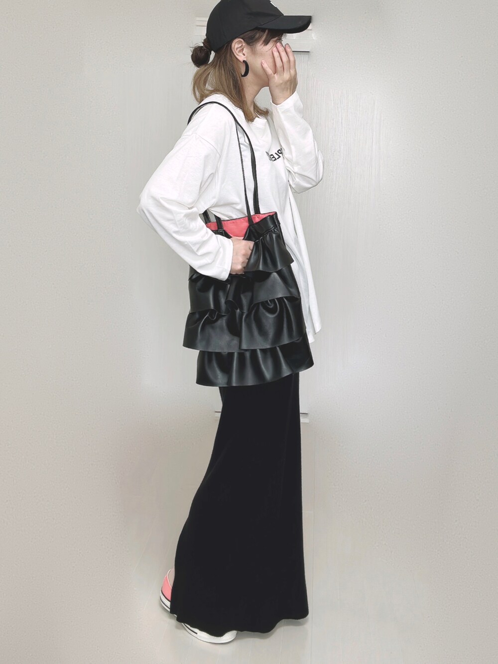 ブラック系のスカート、ピンク系のスニーカーを着用したレディースの秋コーディネートの5枚目の写真