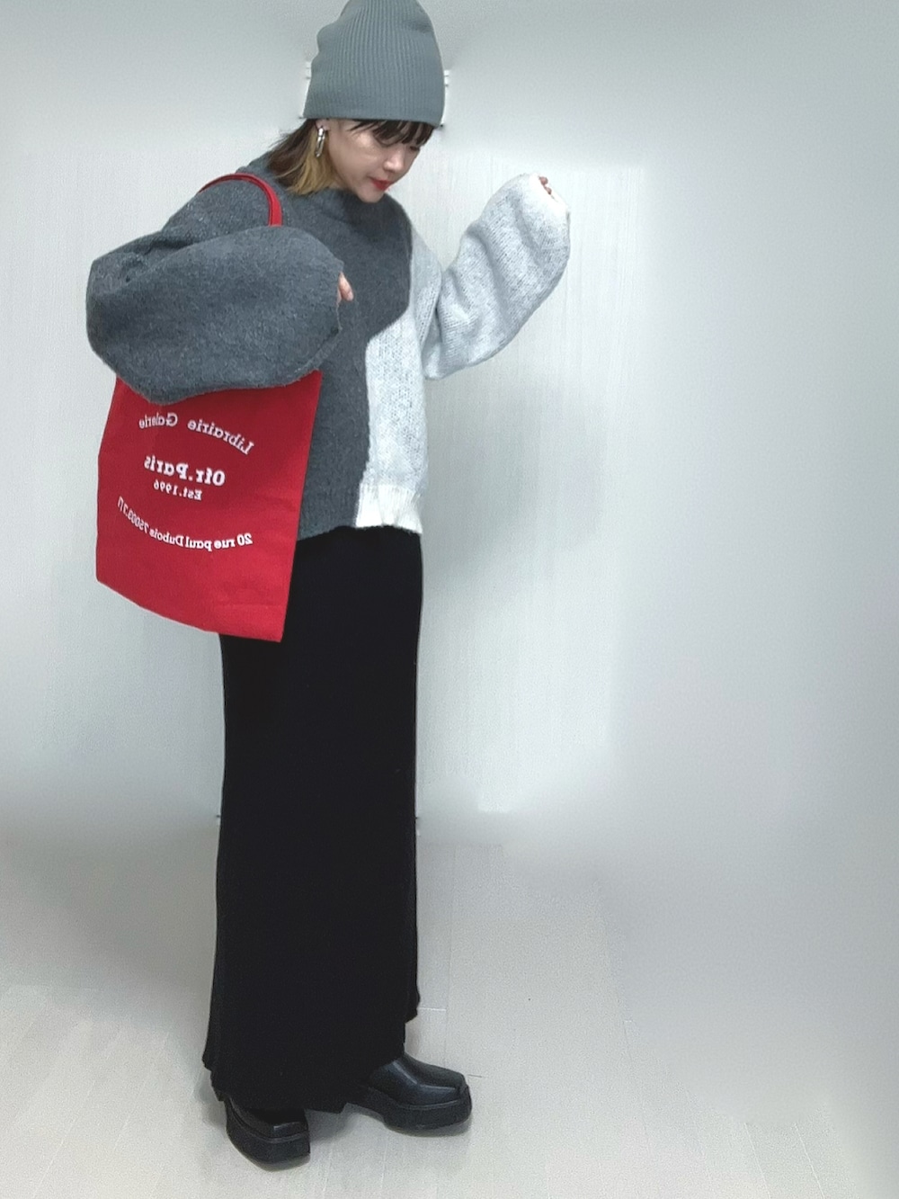 ブラック系のスカート、ブラック系のブーツを着用したレディースの冬コーディネートの3枚目の写真