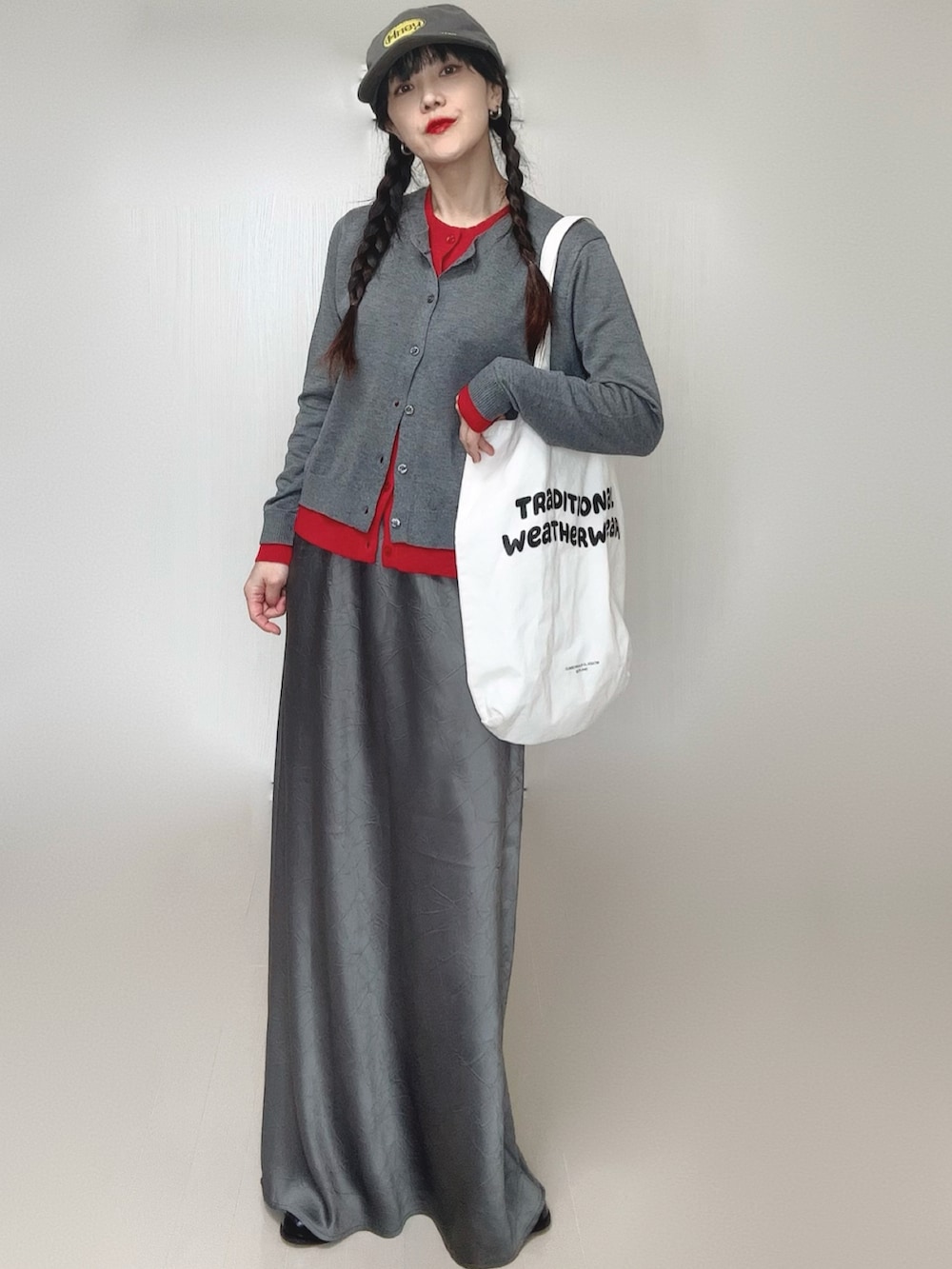 グレー系のカーディガン/ボレロ、グレー系のスカート、ブラック系のローファーを着用したレディースの冬コーディネートの5枚目の写真