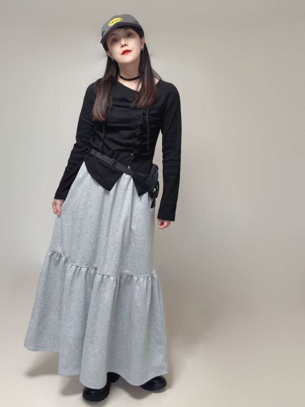 ブラック系のTシャツ/カットソー、グレー系のスカート、ブラック系のボディバッグ/ウエストポーチを着用したレディースの秋コーディネートの4枚目の写真