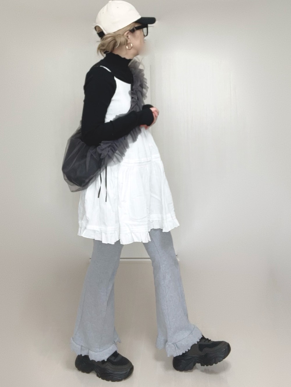 ホワイト系のワンピース、ブラック系のTシャツ/カットソー、グレー系のショルダーバッグを着用したレディースの春コーディネートの3枚目の写真