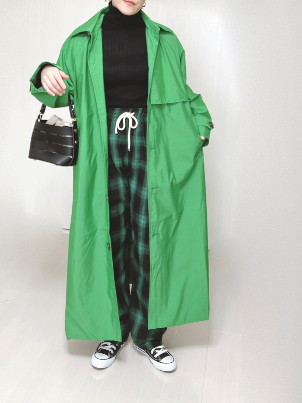 グリーン系のトレンチコート、グリーン系のその他パンツ、ブラック系のショルダーバッグを着用したレディースの春コーディネートの5枚目の写真