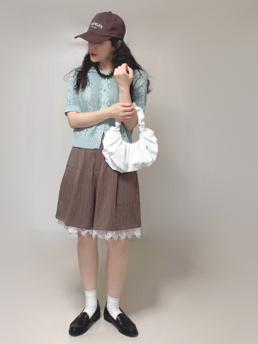 グリーン系のカーディガン/ボレロ、ブラウン系のその他パンツ、ブラック系のローファーを着用したレディースの夏コーディネートの2枚目の写真