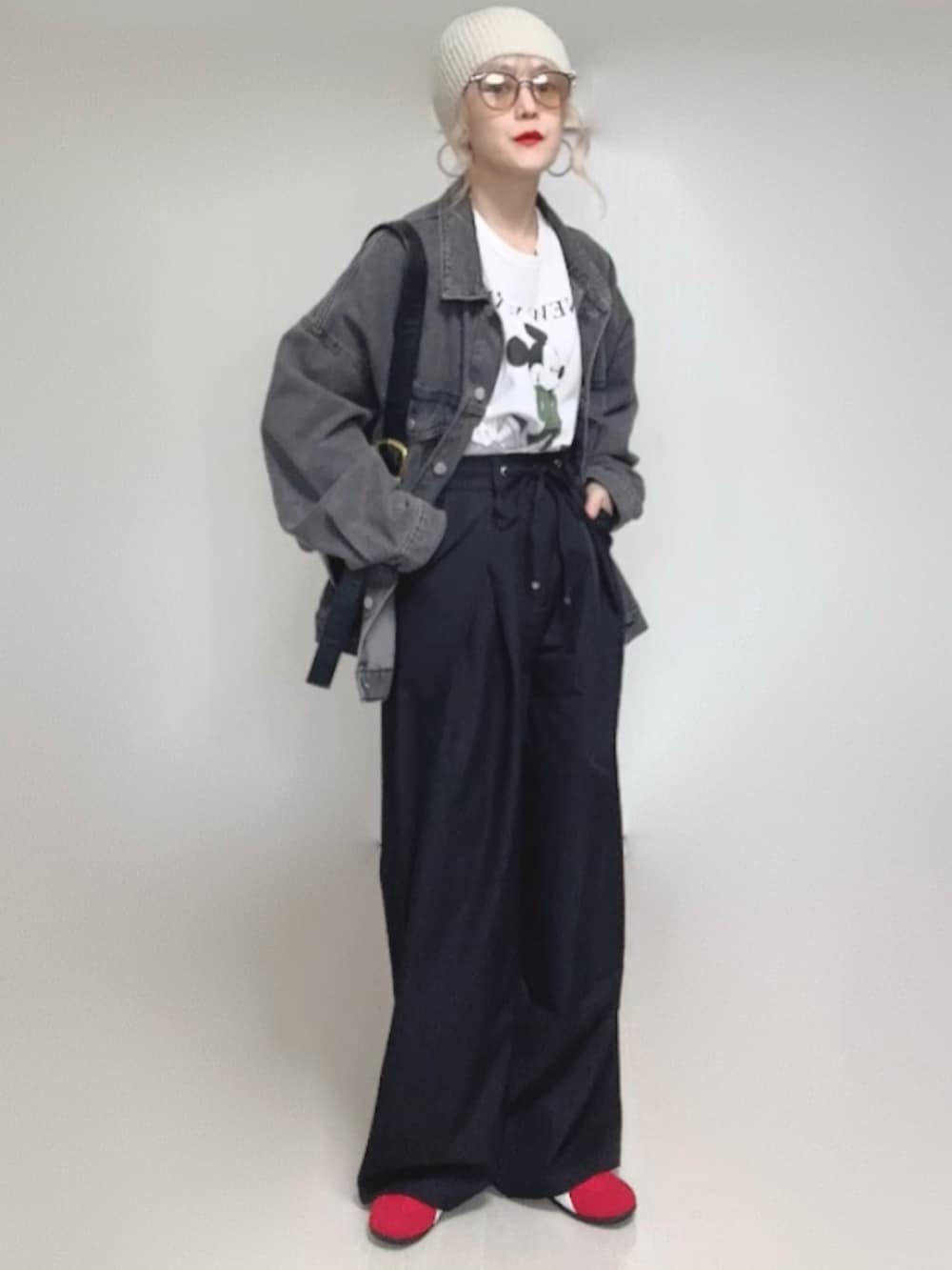 ブラック系のデニムジャケット、ブラック系のスラックス、ホワイト系のTシャツ/カットソーを着用したレディースの冬コーディネートの2枚目の写真