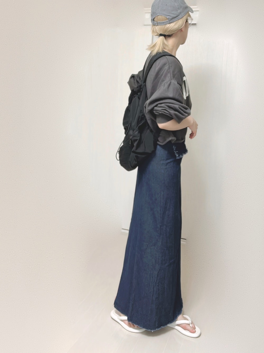 ブルー系のセットアップ、ブラック系のバックパック/リュック、ホワイト系のサンダルを着用したレディースの夏コーディネートの3枚目の写真