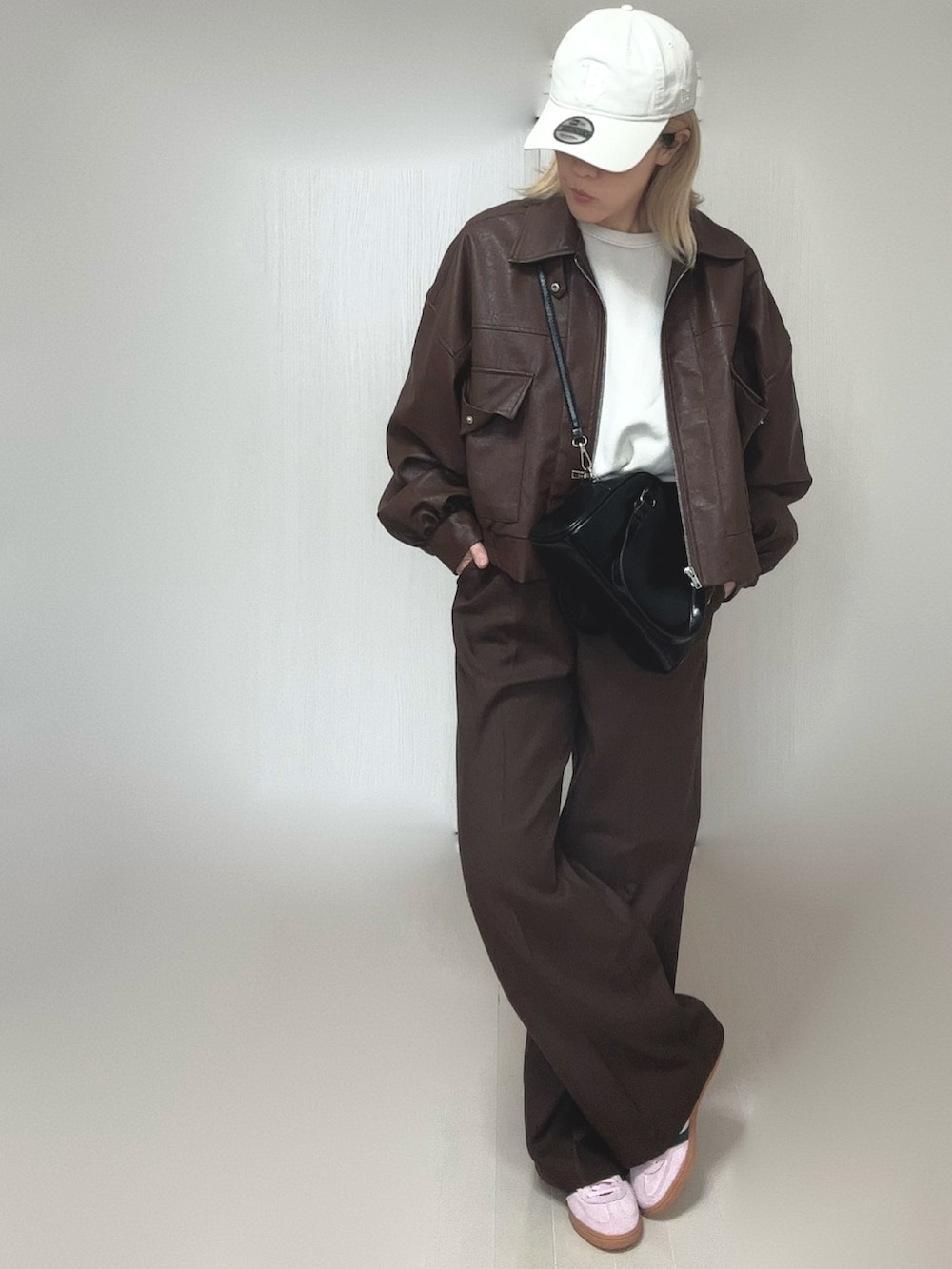 ブラウン系のブルゾン、ブラウン系のその他パンツ、ブラック系のボストンバッグを着用したレディースの冬コーディネートの4枚目の写真