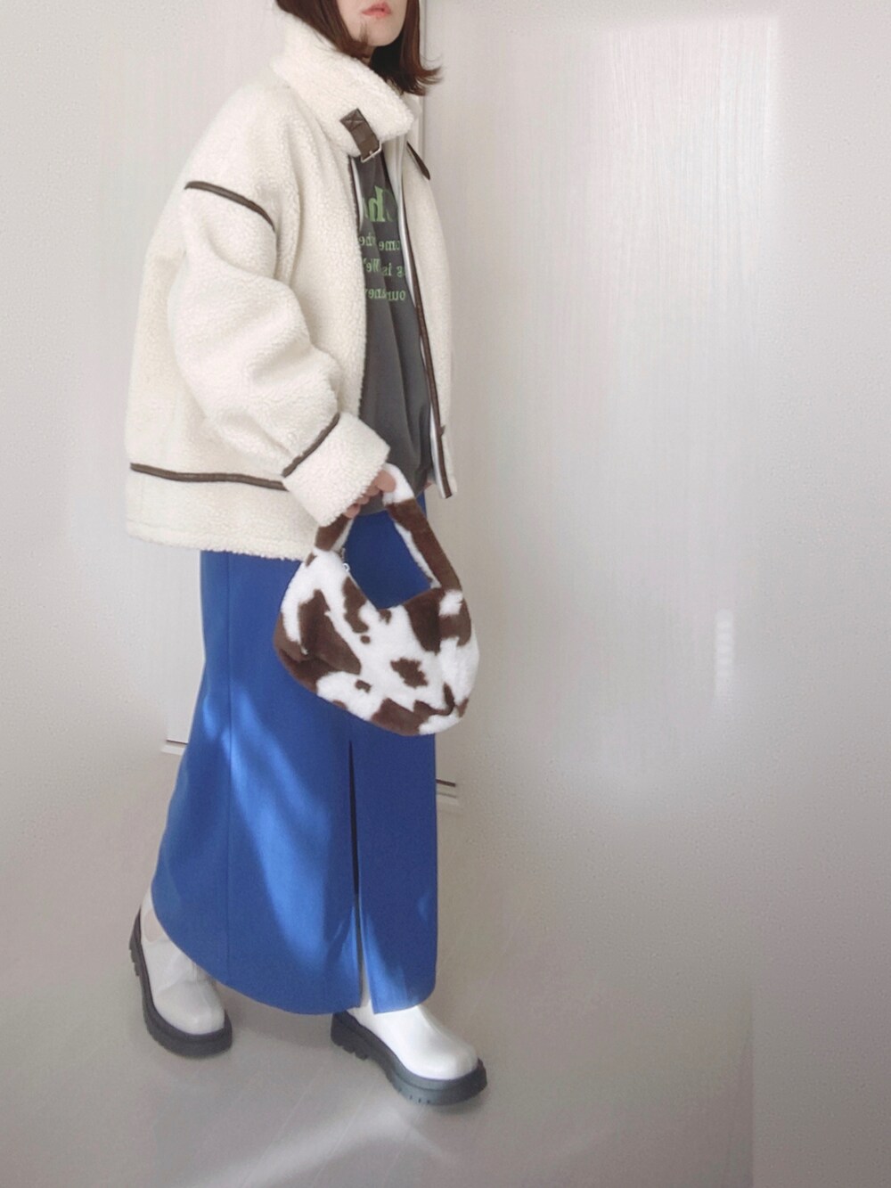 ホワイト系のブルゾン、グレー系のスウェット、ブルー系のスカートを着用したレディースの秋コーディネートの4枚目の写真