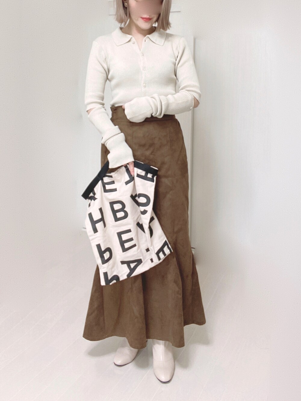 ホワイト系のカーディガン/ボレロ、ベージュ系のムートンコート、ホワイト系のトートバッグを着用したレディースの秋コーディネートの2枚目の写真