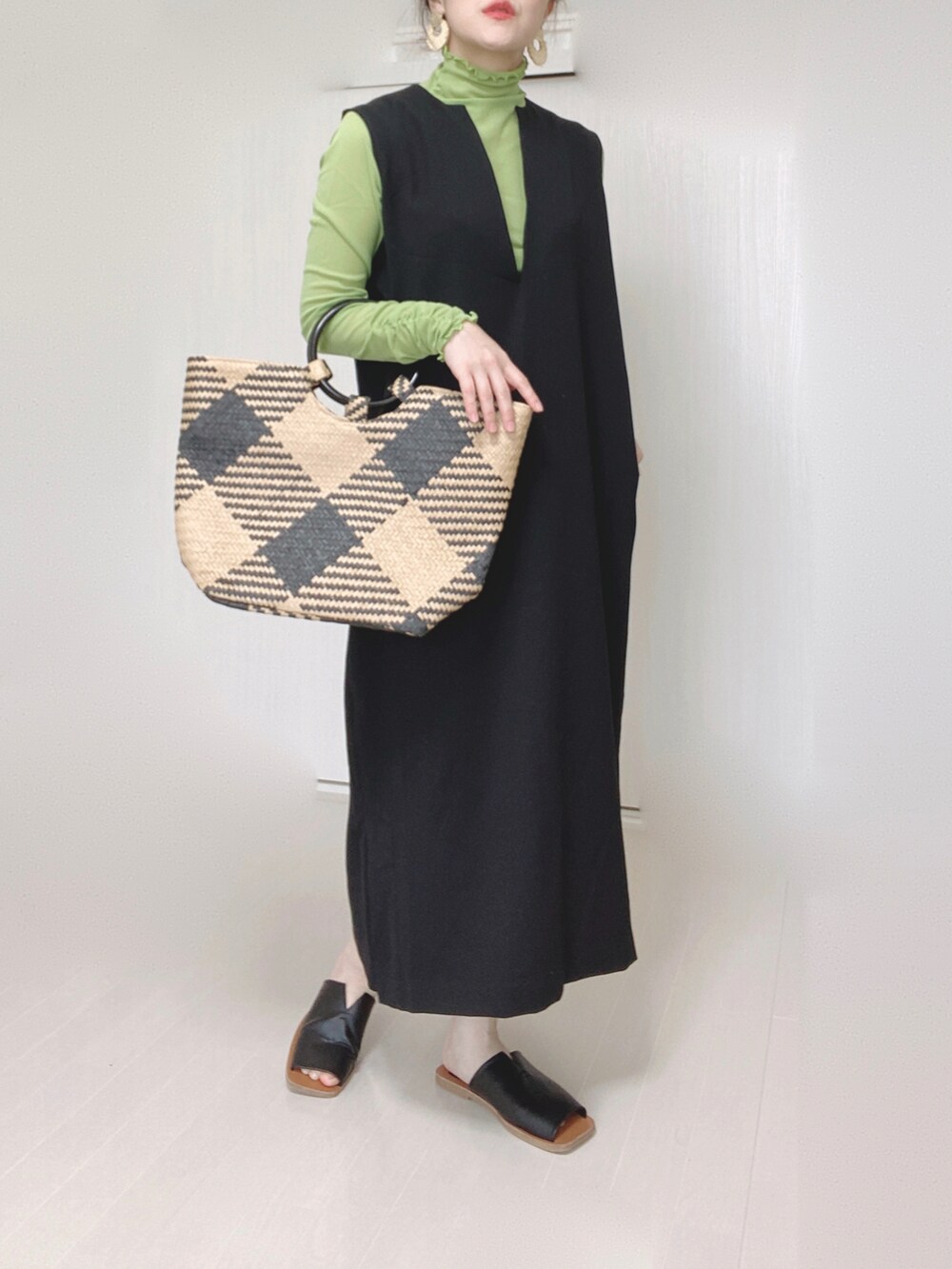 ブラック系のワンピース、ブラック系のトートバッグ、ブラック系のサンダルを着用したレディースの春コーディネートの2枚目の写真