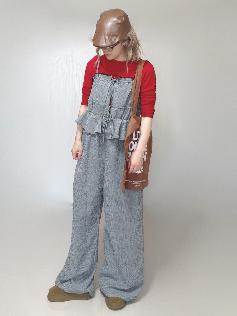グレー系のサロペット/オーバーオール、ブラウン系のトートバッグ、レッド系のTシャツ/カットソーを着用したレディースの夏コーディネートの2枚目の写真