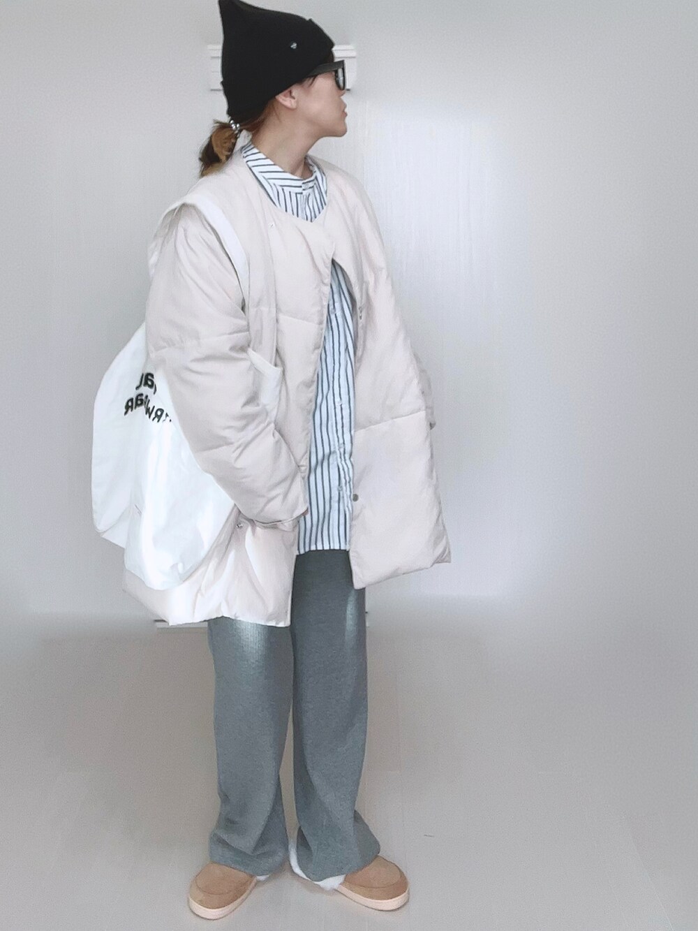 ホワイト系のダウンジャケット/コート、ホワイト系のシャツ/ブラウス、ホワイト系のトートバッグを着用したレディースの冬コーディネートの3枚目の写真